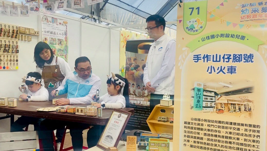 侯友宜市長參觀特色攤位後,來到「手作山仔腳號小火車」體驗區,與教育局長張明文 (右)和小朋友小朋友透過「動中學」,了解地方文化與創意設計。(李育嫺攝)