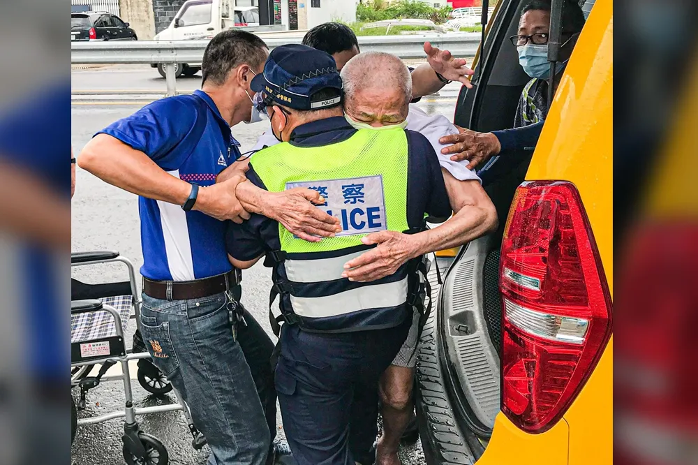 屏東勇警冒雨抱長者下車打疫苗　潘孟安讚「最美的背影」